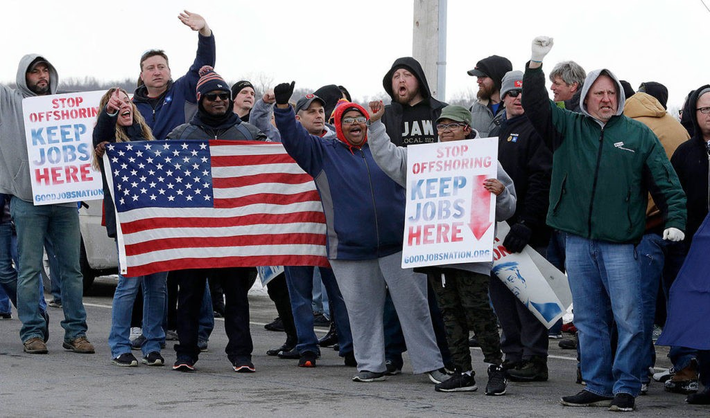 General Motors employees gather outside the plant for a protest, Wednesday, March 6, 2019, in Lordstown, Ohio. General Motors' sprawling Lordstown assembly plant near Youngstown is ending production of the Chevrolet Cruze sedan, ending for now more than 50 years of auto manufacturing at the site. (AP Photo/Tony Dejak)