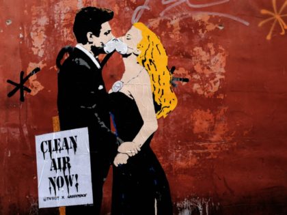 A grafiti by street artist TVBoy shows a scene of famous Italian movie 'La Dolce Vita' with actors Marcello Mastroianni and Anita Ekberg, on November 14, 2017 in Rome. This initiative of environmental NGO Greenpeace with the street artist Tvboy is part of the campaign 'Clean Air Now' to denounce …