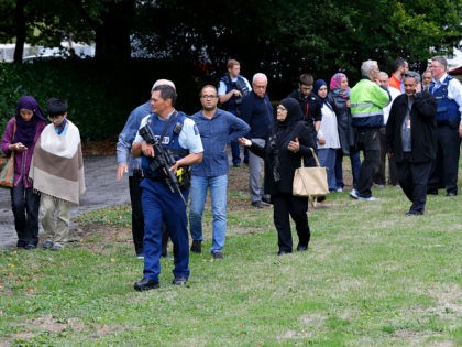 Police escort witnesses away from a mosque in central Christchurch, New Zealand, Friday, M