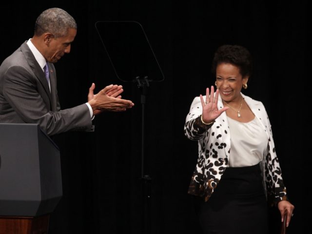 U.S. Attorney General Loretta Lynch (R) waves as President Barack Obama (L) applauds as they arrive at a formal investiture ceremony June 17, 2015 at the Warner Theatre in Washington, DC. Lynch was officially sworn in by Vice President Joe Biden as the 83rd Attorney General of the United States …