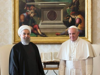 Pope Francis (R) and Iranian President Hassan Rouhani pose during their private audience o