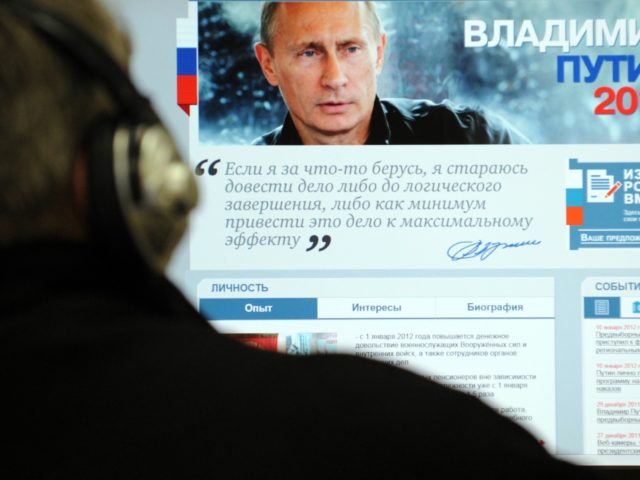 A man looks at a computer monitor displaying the main page of Russian Prime Minister Vladimir Putin's election campaign website, Moscow, on January 12, 2012. In his manifesto for March 2012 presidential elections Putin vowed today to end repressive police behaviour in Russia but also warned that Moscow would retaliate …
