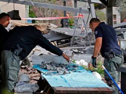 A general view shows emergency responders gathering fragments during their inspection of a damaged house after it was hit by a rocket in the village of Mishmeret, north of Tel Aviv on March 25, 2019. - A rocket hit a house in a community north of Tel Aviv and caused …