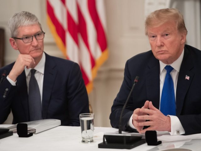 US President Donald Trump speaks alongside Apple CEO Tim Cook (L) during the first meeting