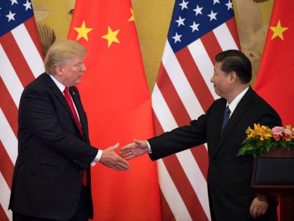 US President Donald Trump (L) shakes hands with China's President Xi Jinping at the end of