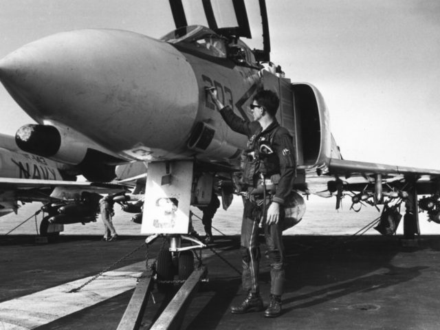 A US pilot touches up the number on a McDonnell Douglas F4 Phantom jet aboard the aircraft