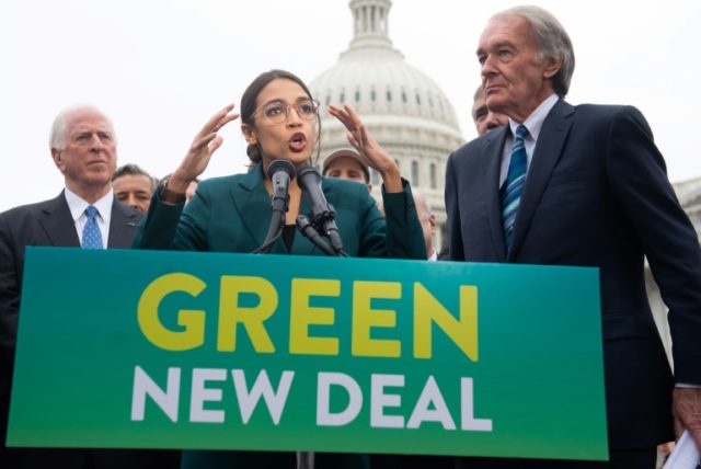 U.S. Rep. Alexandria Ocasio-Cortez (D-NY) speaks as Sen. Ed Markey (D-MA) (R) and other Congressional Democrats listen during a news conference about the Green New Deal resolution in front of the U.S. Capitol on February 7, 2019. (AFP/File SAUL LOEB)