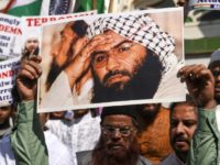Indian Muslims hold a photo of Jaish-e-Mohammad leader Masood Azhar during a protest in Mumbai after an attack on Indian police in Kashmir