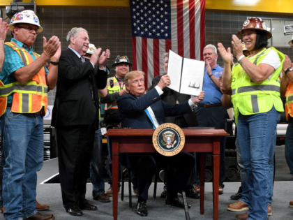 President Donald Trump signs executive orders on energy and infrastructure at the Internat