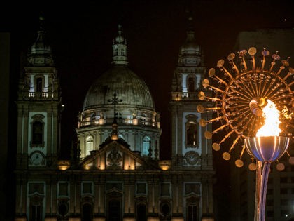 RIO DE JANEIRO, BRAZIL - AUGUST 21: The Olympic flame is seen lit in front of the candelaria church on the Olympic Boulevard while the Rio 2016 closing ceremony takes place at Maracana Stadium on August 21, 2016 in Rio de Janeiro, Brazil. (Photo by Chris McGrath/Getty Images)