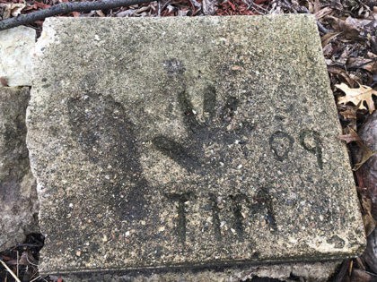 A slab of concrete sits in the backyard of the house where Timmothy Pitzen used to live in