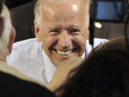 Vice President Joe Biden has a smile for supporters after he addressed a grassroots rally, Tuesday, Aug. 21, 2012, in Minneapolis. (AP Photo/Jim Mone)