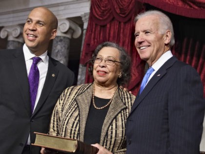 Newly-elected Democratic senator from New Jersey, former Newark Mayor Cory Booker, left, poses for an official photographer with his mother, Carolyn Booker, center, and Vice President Joe Biden, acting in his Constitution role as president of the Senate, at the Capitol in Washington, Thursday, Oct. 31, 2013. (AP Photo/J. Scott …