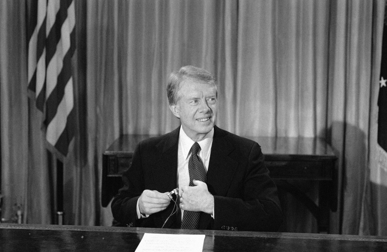 President Jimmy Carter adjusts a microphone before appearing on television from the Oval Office in Washington on Friday, Dec. 10, 1978. He announced that the United States will grant diplomatic recognition to Communist China on New Years day, sever diplomatic relations with Taiwan, and hold a summit meeting in Washington with Communist Vice Premier Deng Hsiao-Ping. (AP Photo)