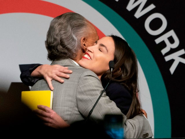 US Representative Alexandria Ocasio-Cortez (R) is welcomed by the Reverend Al Sharpton speaks during a gathering of the National Action Network April 5, 2019 in New York. (Photo by Don Emmert / AFP) (Photo credit should read DON EMMERT/AFP/Getty Images)