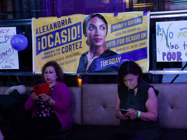 People check the latest mid-terms results on thier phones while celebrating Alexandria Ocasio-Cortez congressional race big win during her election night party in the Queens Borough of New York on November 6, 2018. - 28-year-old Alexandria Ocasio-Cortez from New Yorks 14th Congressional district won Tuesdays election, defeating Republican Anthony Pappas. …