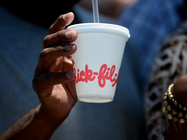 A man carries he drink outside a Chick-Fil-A fast food restaurant in Hollywood, California August 1, 2012. Thousands of Americans turned out Wednesday to feast on fried chicken in a politically-charged show of support for a family owned fast-food chain which opposes same-sex marriage. Long lines and traffic jams were …