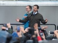 Chasten Glezman (L) joins his husband South Bend Mayor Pete Buttigieg on stage as they greet an overflow crowd at a rally where Buttigieg announced that he will be seeking the Democratic nomination for president on April 14, 2019 in South Bend, Indiana. Buttigieg has been drumming up support for …