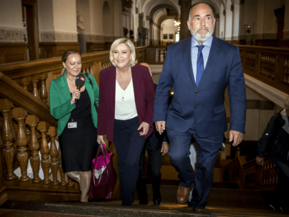 Head of France’s National Rally Marine Le Pen, centre, walks with Denmark politician Soeren Espersen, right who is chairman of the Foreign Policy Committee, during a visit to Christiansborg Palace in Copenhagen, Denmark, Friday April 26, 2019. (Mads Claus Rasmussen/Ritzau Scanpix via AP)