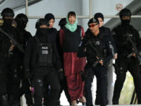 Vietnamese national Doan Thi Huong (C) is escorted by Malaysian police out of the High Court in Shah Alam on April 1, 2019. - A Vietnamese woman accused of assassinating the North Korean leader's half-brother was sentenced to three years and four months in jail after accepting a lesser charge …