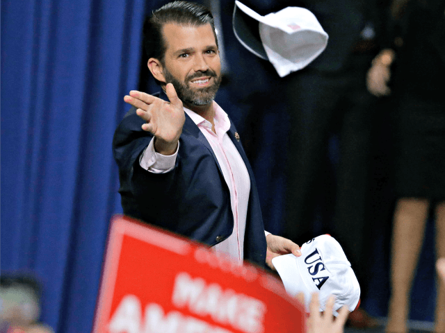 Donald Trump Jr. tosses hats to the crowd before speaking ahead of his father President Donald Trump at a Make America Great Again rally Saturday, April 27, 2019, in Green Bay, Wis. (AP Photo/Mike Roemer)