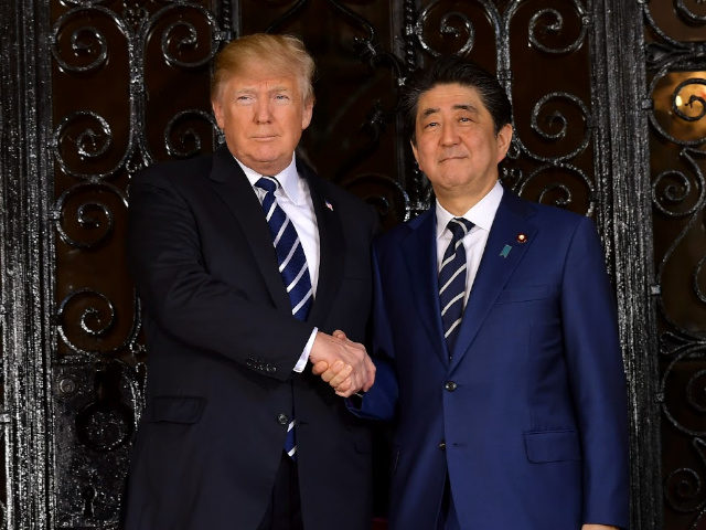 US President Donald Trump greets Japanese Prime Minister Shinzo Abe as he arrives for talk