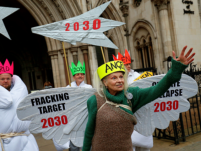 TOPSHOT - British fashion designer Vivienne Westwood, dressed as an angel, poses with other anti-fracking activists, dressed as Joseph, and the three wise men, as the demonstrate outside the Royal Courts of Justice, Britain's High Court, in central London on December 18, 2018. - Anti-fracking activists, including Talk Fracking, of â¦