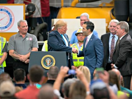 President Donald Trump shakes hands with Texas Land Commissioner George P. Bush at the International Union of Operating Engineers International Training and Education Center Wednesday, April 10, 2019, in Crosby, Texas. (AP Photo/Juan DeLeon)