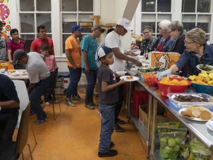 Migrants receive food from volunteers at Centro San Juan Diego shelter in El Paso, Texas November 4, 2018 night, the shelter is currently housing migrants from Central America and Mexico who have sought asylum because of political instability. - Sending thousands of troops to the US-Mexico border to counter a …