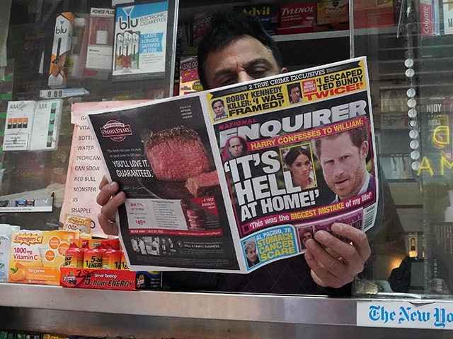 A newspaper vendor on Third Avenue in midtown New York City displays a copy of the National Enquirer for a photographer at his newstand February 8, 2019. - The publisher of the National Enquirer said Friday, February 8, 2019 it would open an internal probe of accusations by Amazon's Jeff …