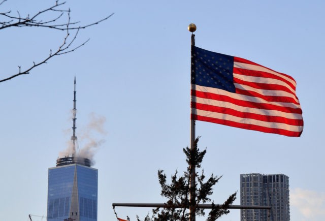 One World Trade Center and the American Flag are seen from Brooklyn Bridge Park on March 7