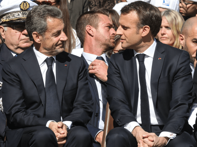 French President Emmanuel Macron (R) and his predecessor Nicolas Sarkozy attend a ceremony