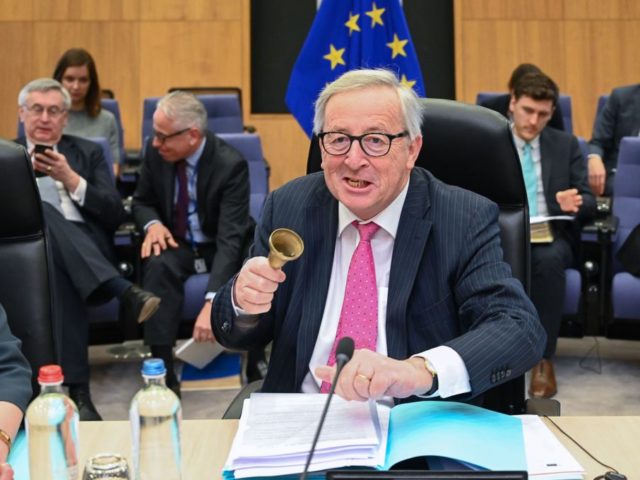 TOPSHOT - President of the European Commission Jean-Claude Juncker (C) rings a bell to ope