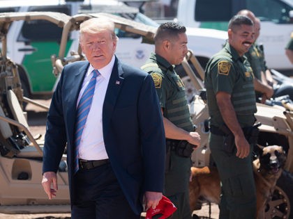 US President Donald Trump speaks with members of the US Customs and Border Patrol as he tours the border wall between the United States and Mexico in Calexico, California on April 5, 2019. - President Donald Trump landed in California to view newly built fencing on the Mexican border, even …