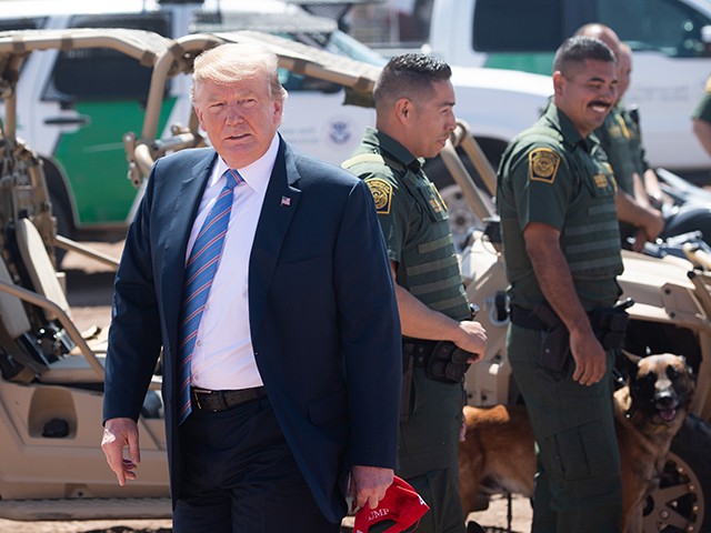 US President Donald Trump speaks with members of the US Customs and Border Patrol as he tours the border wall between the United States and Mexico in Calexico, California on April 5, 2019. - President Donald Trump landed in California to view newly built fencing on the Mexican border, even as he retreated from a threat to shut the frontier over what he says is an out-of-control influx of migrants and drugs. (Photo by SAUL LOEB / AFP) (Photo credit should read SAUL LOEB/AFP/Getty Images)