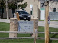 Police patrol outside a locked Columbine High School on April 17, 2019 in Littleton, Colorado, as all Denver-area schools were evacuated and classes cancelled after an active threat to the area made by Sol Pais. - A US teenager has been found dead after a massive search by authorities who …