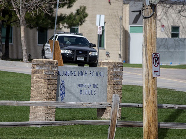 Police patrol outside a locked Columbine High School on April 17, 2019 in Littleton, Color