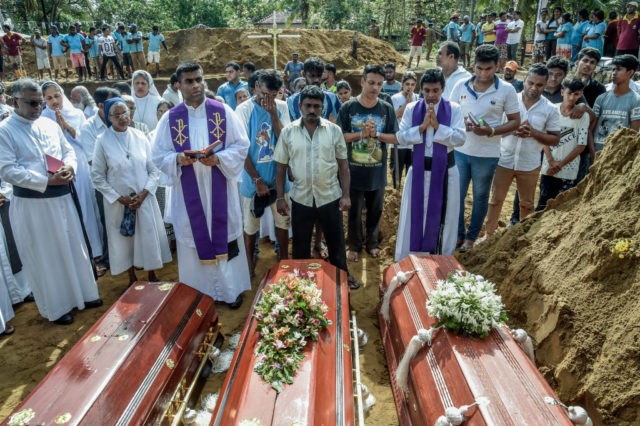COLOMBO, SRI LANKA - APRIL 23: Relatives of the dead offer their prayers during funerals in Katuwapity village on April 23, 2019 in Negambo, Sri Lanka. At least 311 people were killed with hundreds more injured after coordinated attacks on churches and hotels on Easter Sunday rocked three churches and …