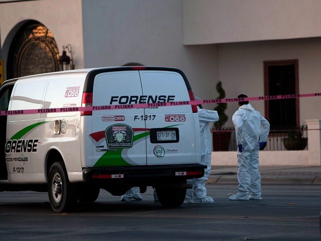 Mexican forensic personnel wait outside an exclusive restaurant in Ciudad Juarez, Chihuahua state, Mexico on May 07, 2013, after four men were killed inside the facilitiy by a gang armed with AK-47 assault rifles. AFP PHOTO/JESUS ALCAZAR (Photo credit should read Jesus Alcazar/AFP/Getty Images)