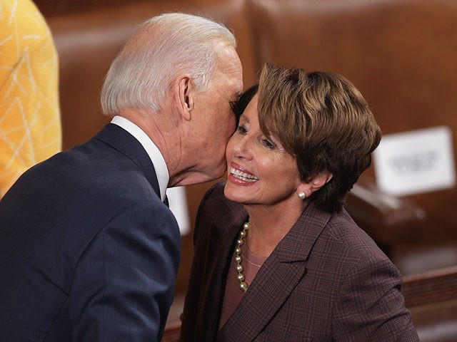 WASHINGTON, DC - JANUARY 28: Vice President Joe Biden (L) kisses House Minority Leader Nancy Pelosi (D-CA) before U.S. President Barack Obama delivers the State of the Union address to a joint session of Congress in the House Chamber at the U.S. Capitol on January 28, 2014 in Washington, DC. …