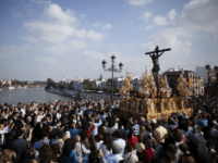 People attend a procession of 'El Cachorro' brotherhood during Holy Week celebrations in Sevilla on April 18, 2014. Christian believers around the world mark the Holy Week of Easter in celebration of the crucifixion and resurrection of Jesus Christ. AFP PHOTO/ GOGO LOBATO (Photo credit should read GOGO LOBATO/AFP/Getty Images)