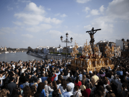 People attend a procession of 'El Cachorro' brotherhood during Holy Week celebra