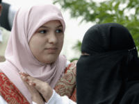 ISLAMABAD, PAKISTAN - DECEMBER 9: Scottish schoolgirl, Misbah Rana (aka Molly Campbell) stands next to a woman wearing a burqua during a human rights protest outside outside Parliament House on December 9, 2006 in Islamabad, Pakistan. Misbah announced she wishes to become active in Pakistani human rights issues and urged …