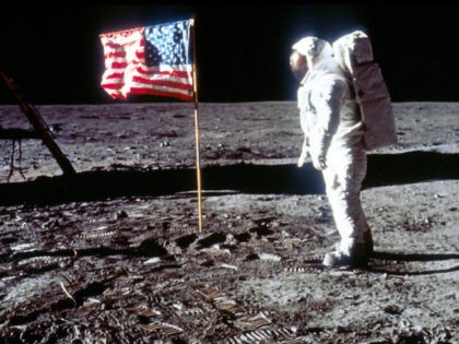 060280 01: Astronaut Edwin "Buzz" Aldrin poses next to the U.S. flag July 20, 19