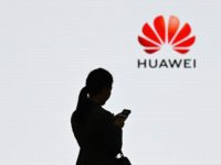 A staff member of Huawei uses her mobile phone at the Huawei Digital Transformation Showcase in Shenzhen, China's Guangdong province on March 6, 2019. - Chinese telecom giant Huawei insisted on March 6 its products feature no security 'backdoors' for the government, as the normally secretive company gave foreign media …
