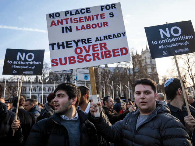 LONDON, ENGLAND - MARCH 26: Protesters hold placards as they demonstrate in Parliament Square against anti-Semitism in the Labour Party on March 26, 2018 in London, England. The Board of Deputies of British Jews and the Jewish Leadership Council have drawn up a letter accusing Labour Leader Jeremy Corbyn of …