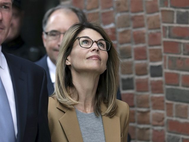 Actress Lori Loughlin departs federal court in Boston on Wednesday, April 3, 2019, after facing charges in a nationwide college admissions bribery scandal. (AP Photo/Charles Krupa)