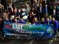 People hold a banner reading 'March of the Living' as they take part in the march in the centre of Budapest on April 17, 2016. The 'March of the Living' commemorates the victims of the Holocaust. / AFP / ATTILA KISBENEDEK (Photo credit should read ATTILA KISBENEDEK/AFP/Getty Images)
