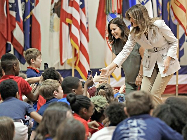 First lady Melania Trump, right, and second lady Karen Pence, left, greet student at Albritton Middle School in Fort Bragg, N.C., Monday, April 15, 2019. (AP Photo/Chuck Burton)