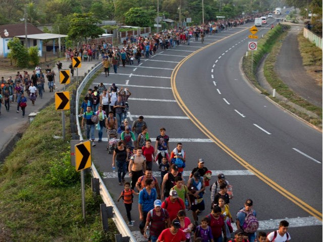 Central American migrants, part of the caravan hoping to reach the U.S. border, walk on the shoulder of a road in Frontera Hidalgo, Mexico, Friday, April 12, 2019. The group pushed past police guarding the bridge and joined a larger group of about 2,000 migrants who are walking toward Tapachula, …